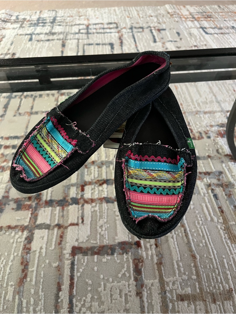 Sanuk Black Slip-On Moccasins with Multicolor Striped Panel